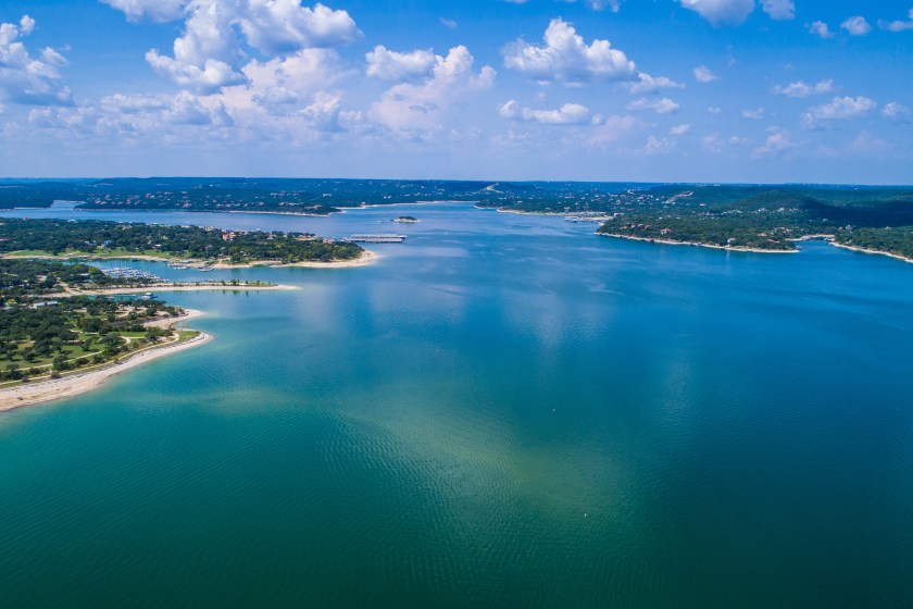 Aerial view above Lake Travis and Lakeway Homes along Water's Edge