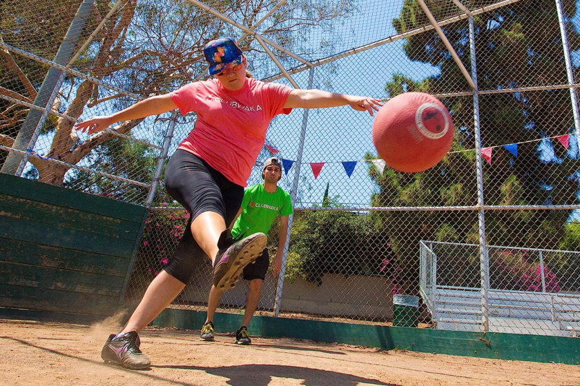 Player kicks the ball at home plate.