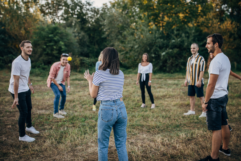 Friends playing toss in a field