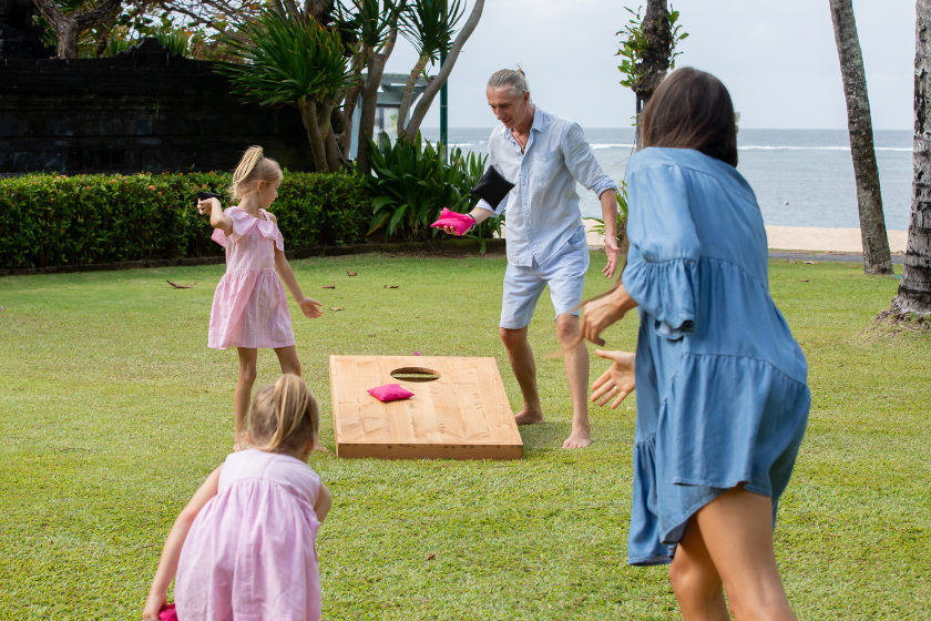 A family playing corn hole. 