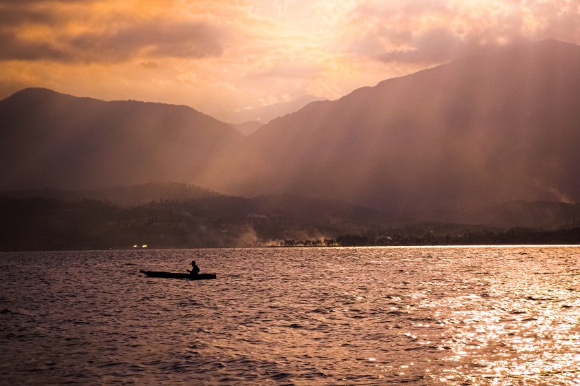 Fishermen catch fish in Singkarak lake on a sunny afternoon, West Sumatra, Indonesia.