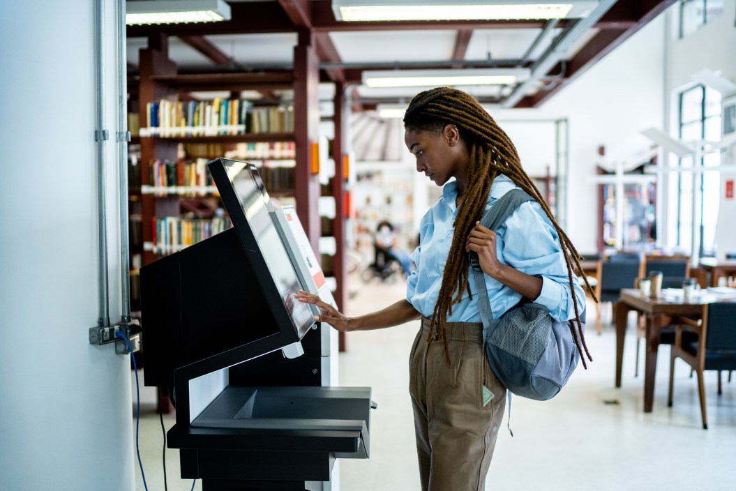 Student searching for a book in the library system