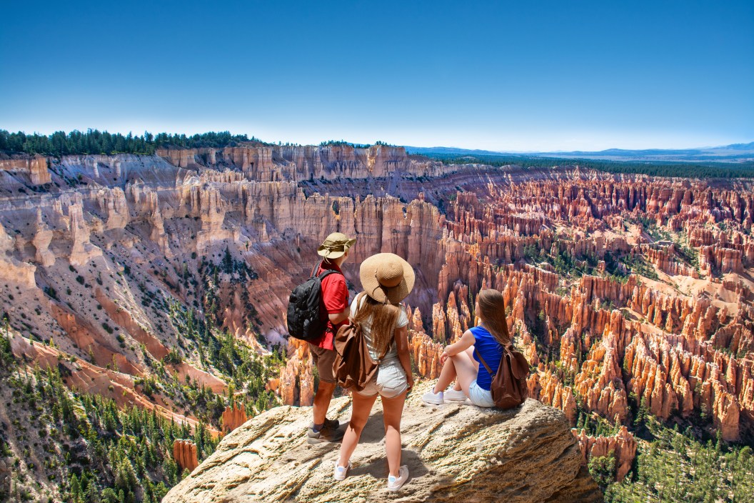People on hiking trip. Family on top of mountain enjoying time together, looking at beautiful view. Inspiration Point, Bryce Canyon National Park, Utah, USA