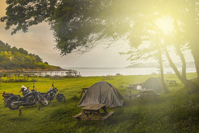 Tent camping and motorcycles at sunset
