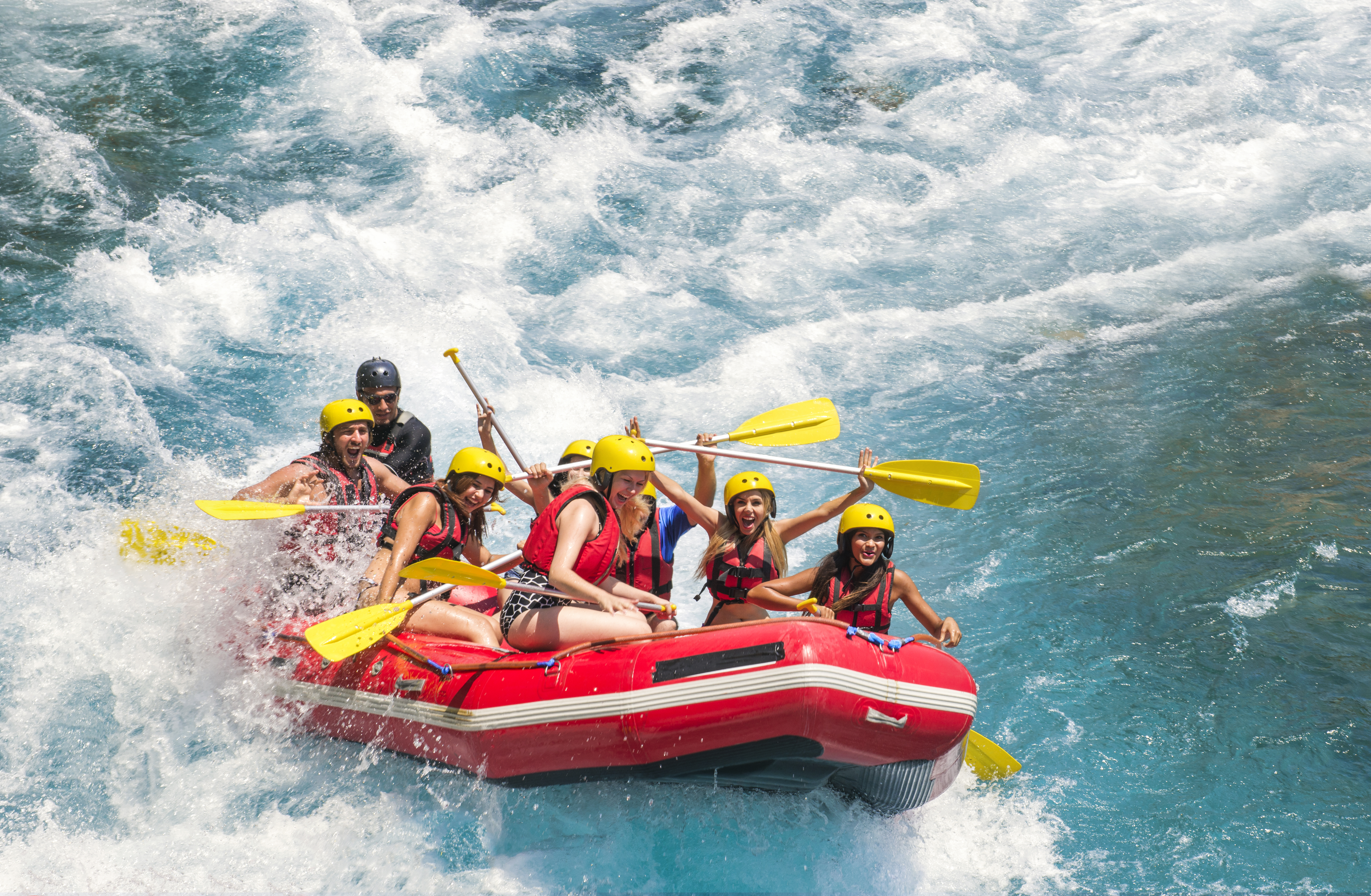 Group of people white water rafting