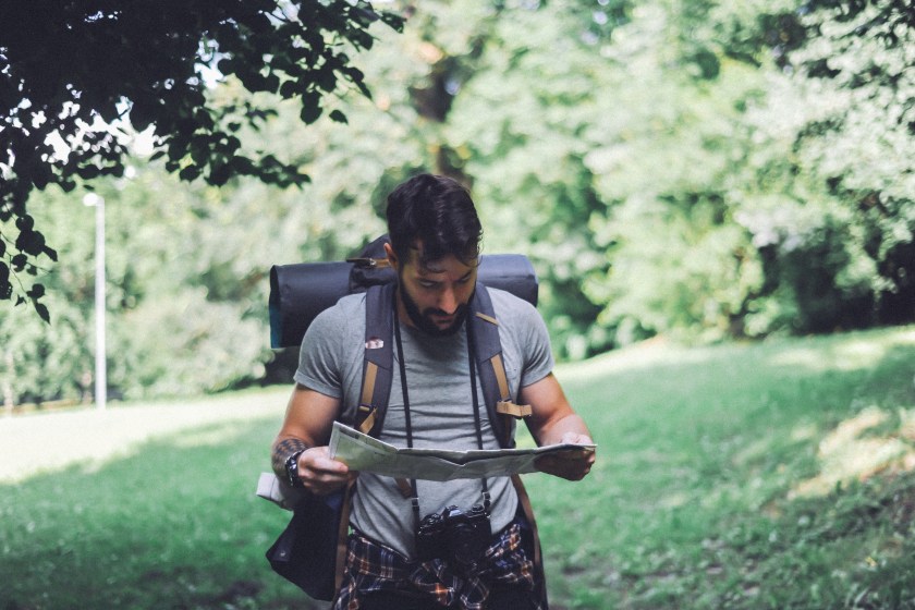Young man hiking, exploring wild nature