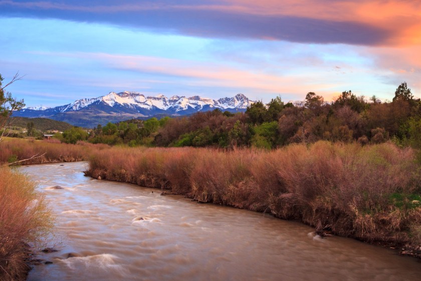 Sunset at Ridgway State Park, Colorado with the snow capped San Juan Mountains in the background.