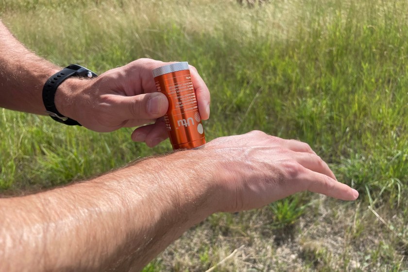Person applying Utu Sunscreen onto their arm