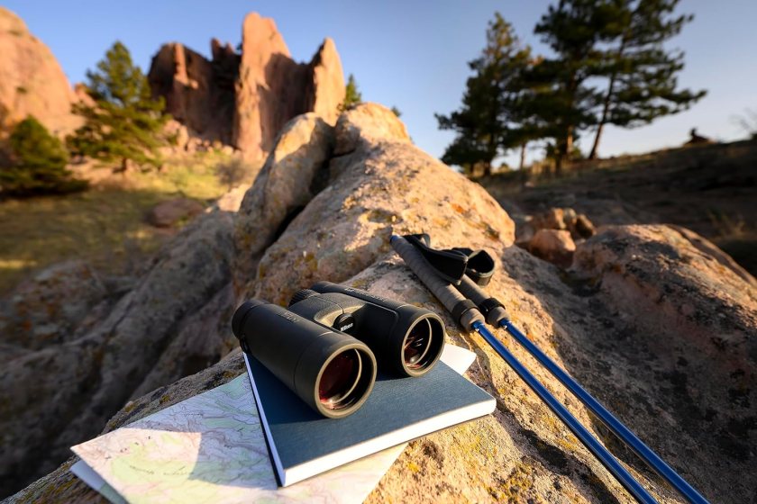 A pair of black Nikon ProStaff P7 10x42 Binoculars on a canyon rock