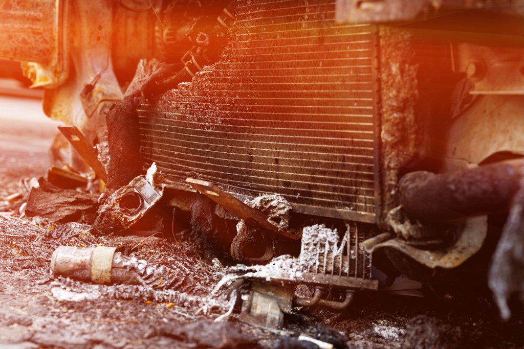 A close-up of a damaged car radiator after a fire to illustrate an article about a fire, an insured event, damage compensation. Tinted