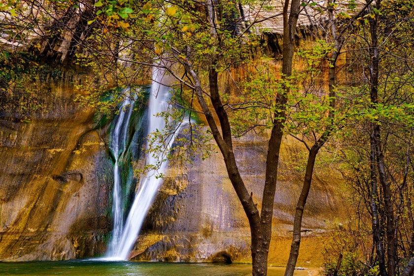 Scenic Calf Creek Falls Escalante - Landscape scenic with red rock canyon walls and flowing waterfall.
