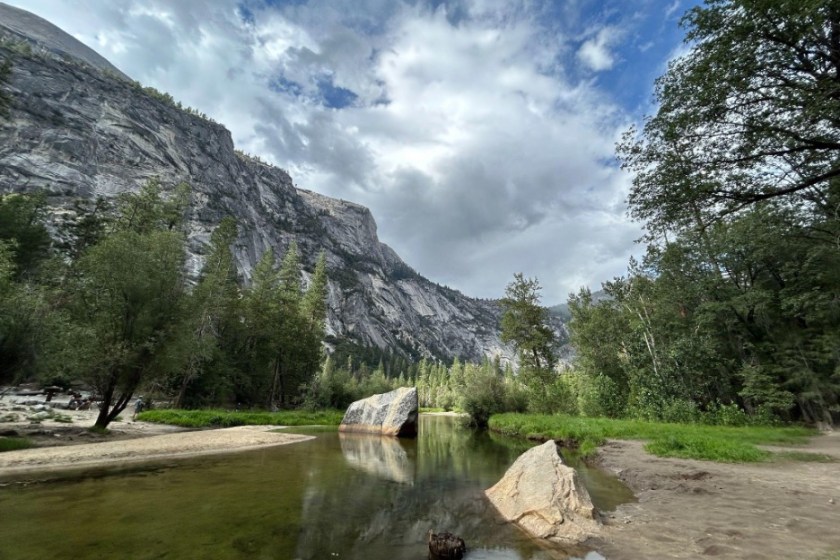 A body of water, trees, and mountains found on the Mirror Valley Trail