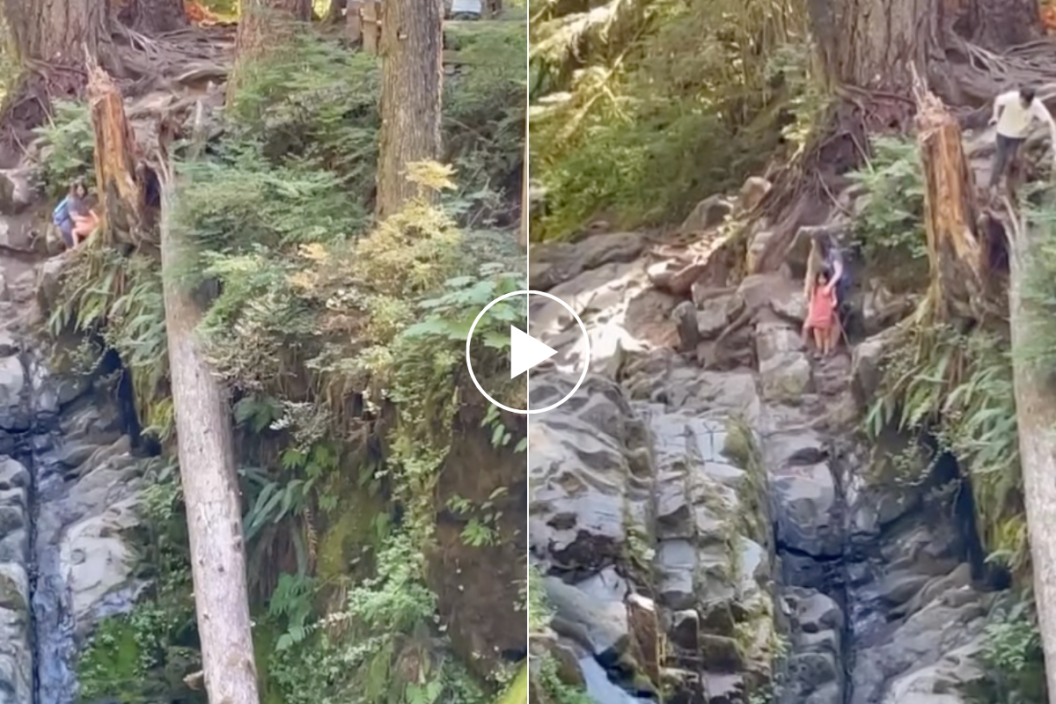 Tourist brings child close to the waterfalls edge.