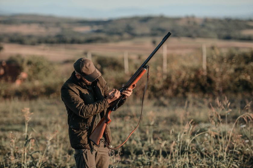 A duck hunter practices with a shotgun.