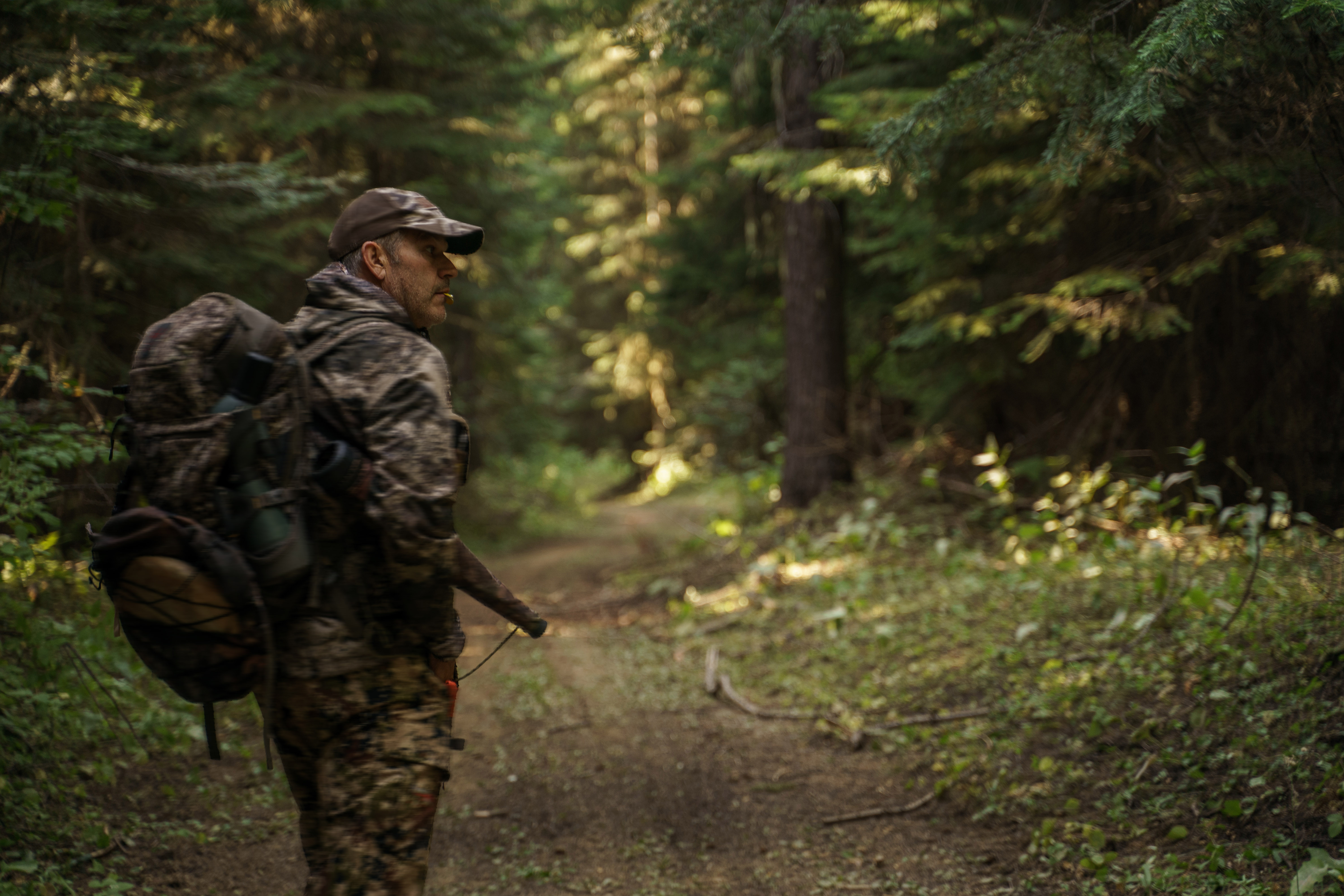 A man with a full bowhunting pack.