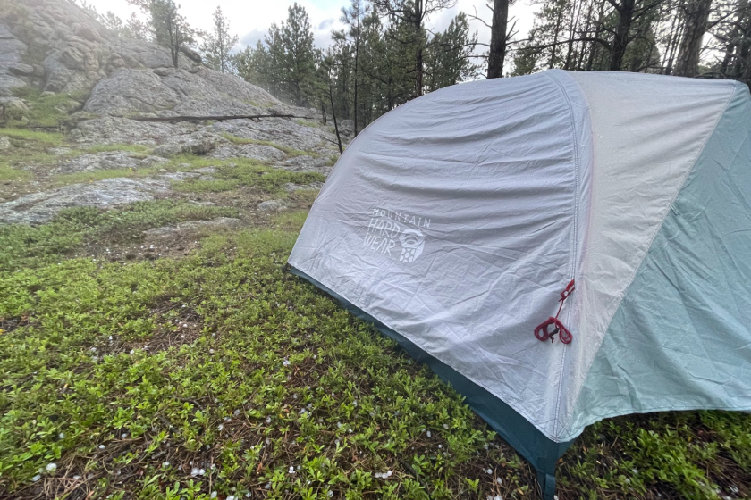 A white and gray camping tent in rainy weather