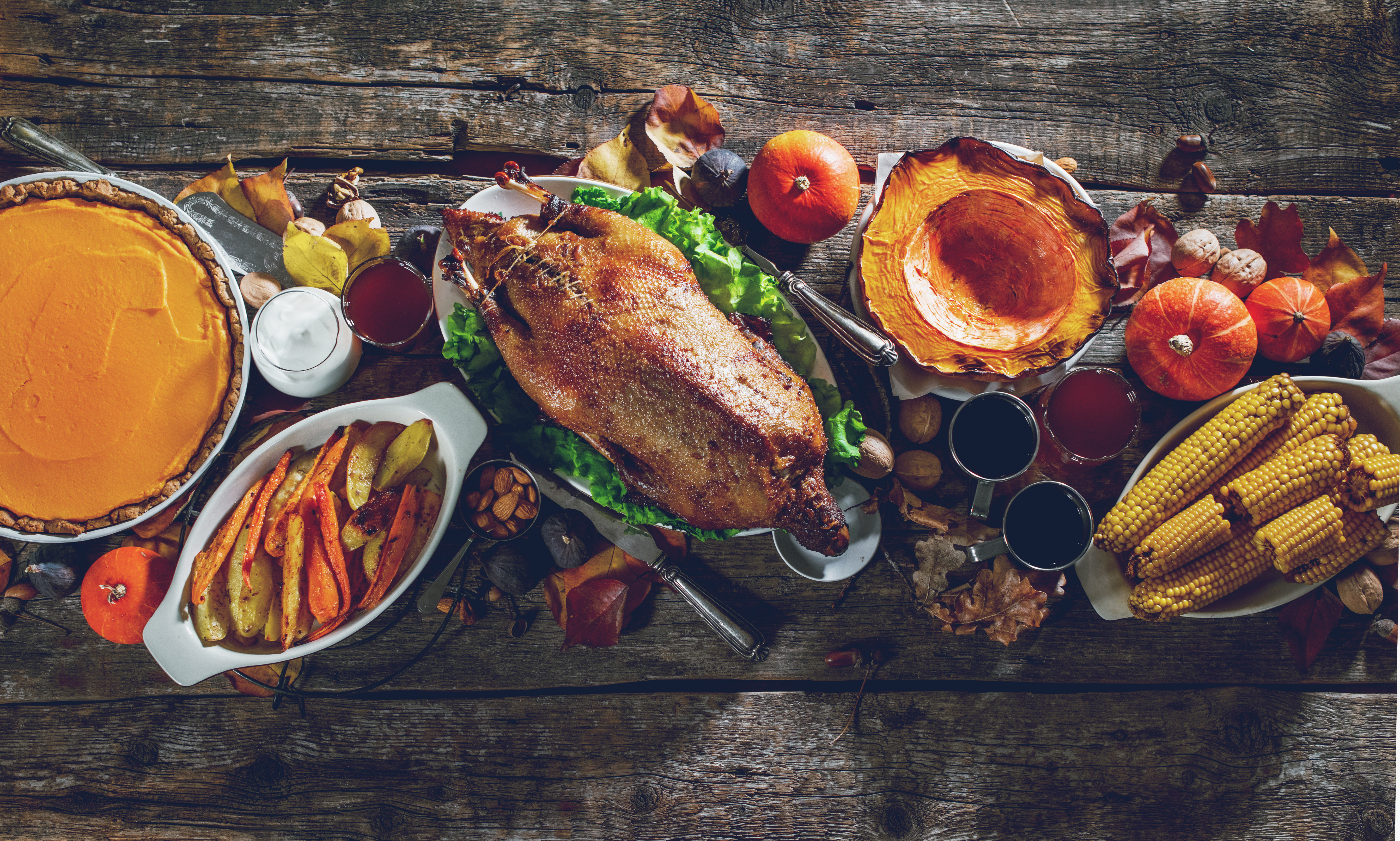 Christmas or Thanksgiving celebration traditional dinner roasted duck setting meal on rustic wooden vintage table. Concept top view