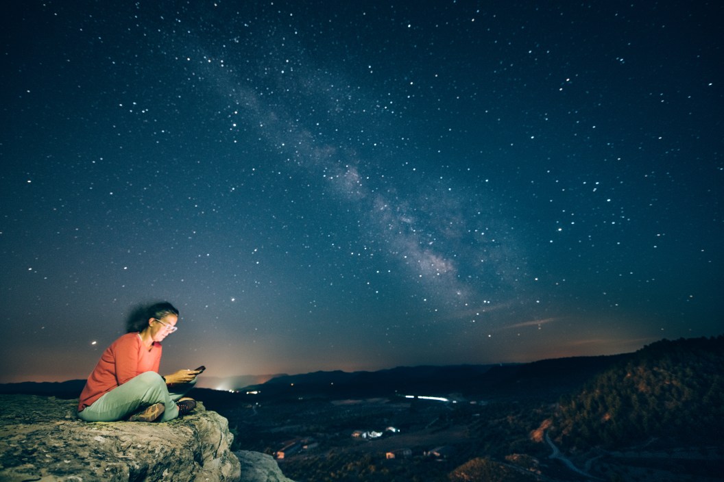 woman using a stargazing app on her phone