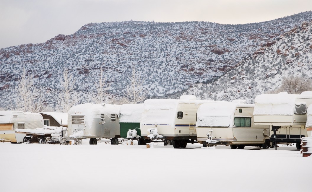 A row of RV trailers covered with a fresh layer of snow. Located in Arizona. Taken in December 2009.