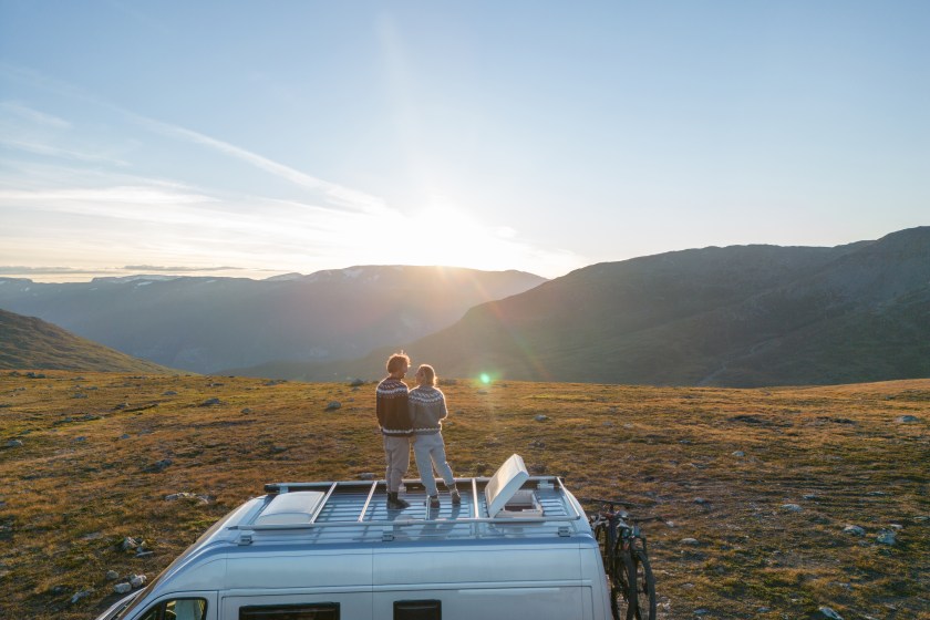 People travel, alternative homes concept. They enjoy the nature right outside a mobile home.