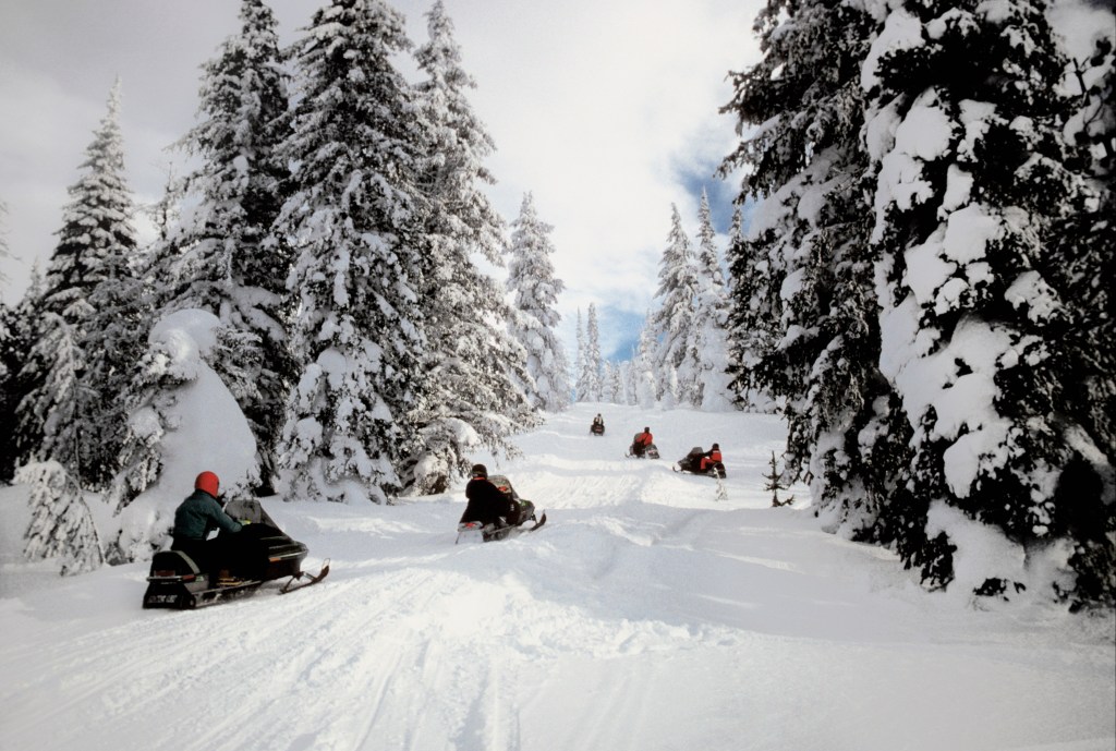 People on snowmobiles in Yellowstone National Park in Wyoming, USA