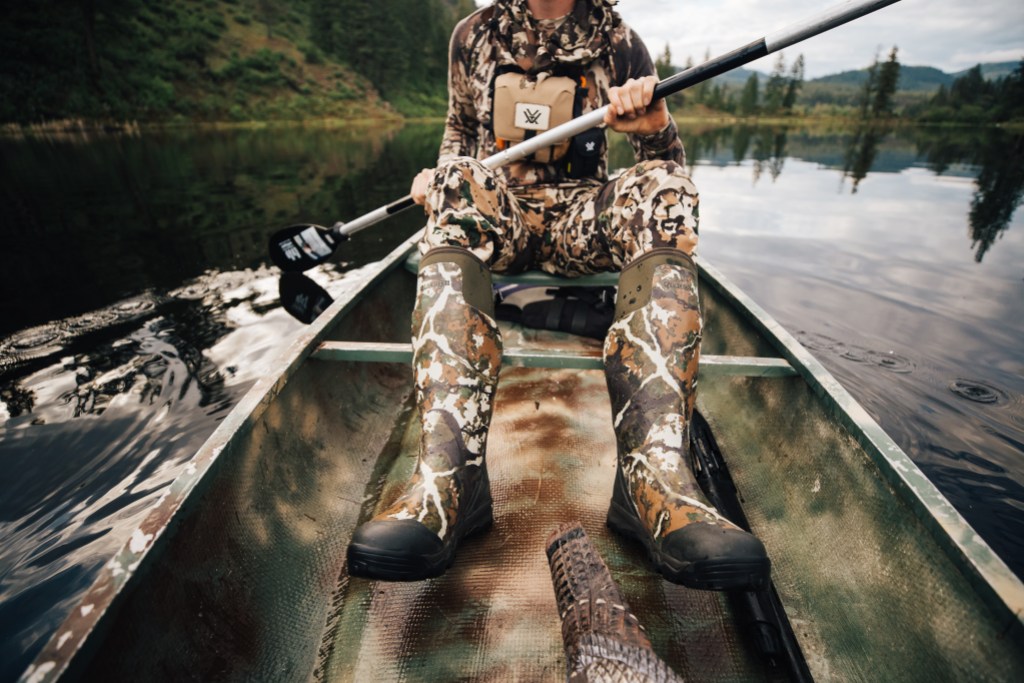 Person in a camouflage outfit sitting inside a boat