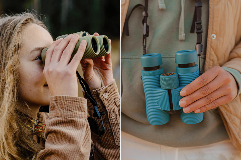 A person holding up a pair of teal binoculars