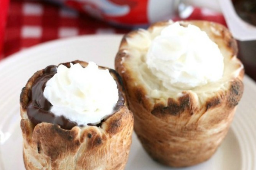 dough cups filled with chocolate and whipped cream