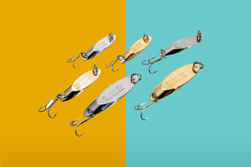 A series of silver and gold fishing spoons on a blue and yellow background
