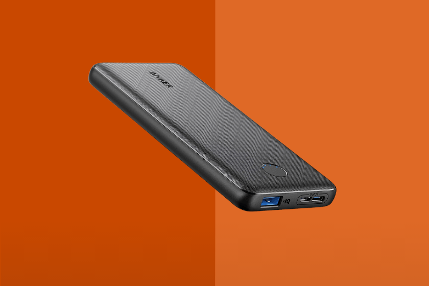 A black Anker portable charger with an orange background