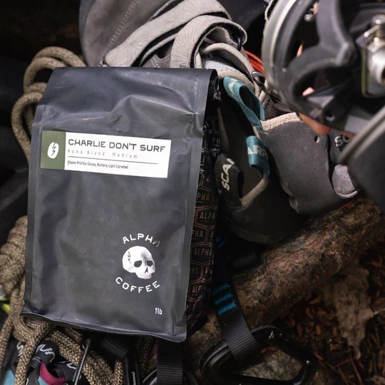 A bag of ground coffee clipped to a hiker's pack