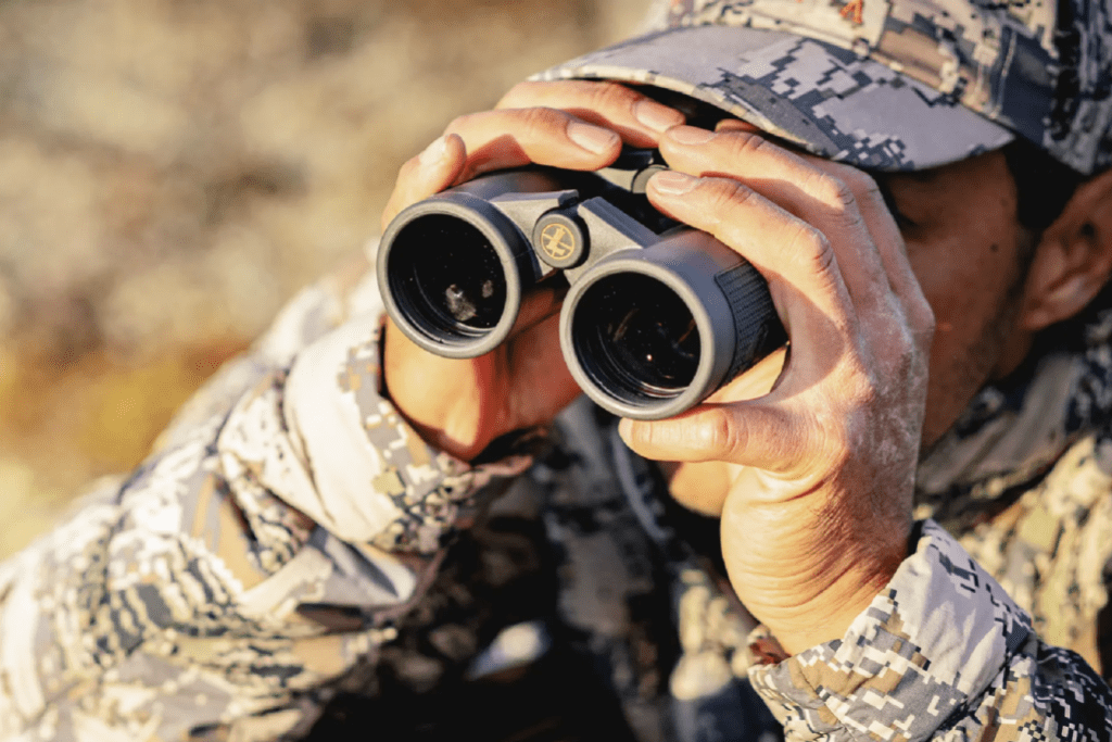Person using a pair of binoculars while hunting