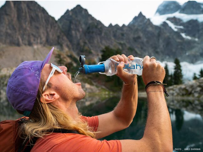 Person drinking from a Platypus water bottle 