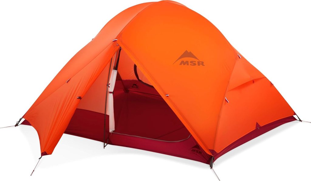 Orange MSR tent on a plain white background
