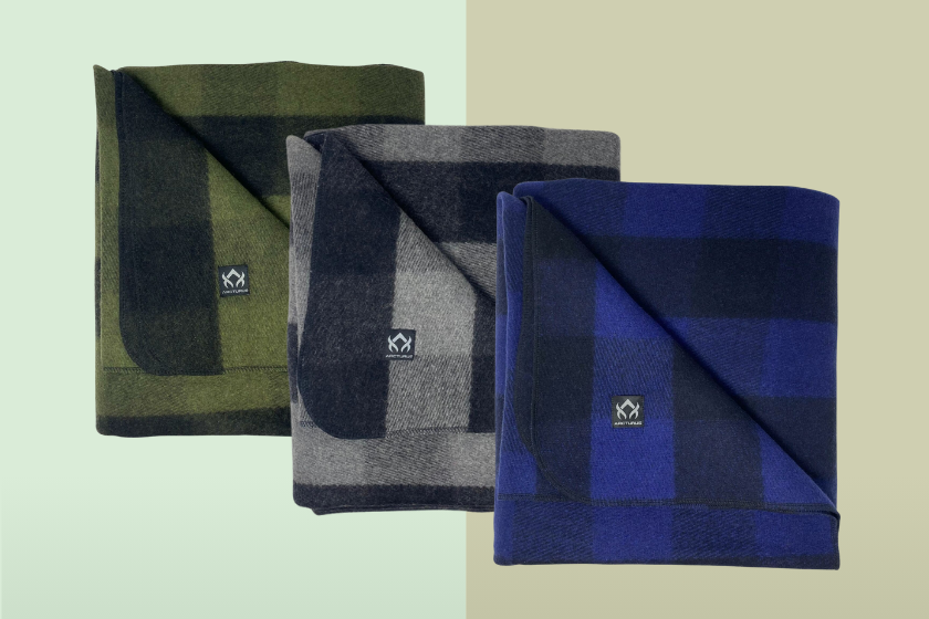 Three wool blankets placed in squares on a green background