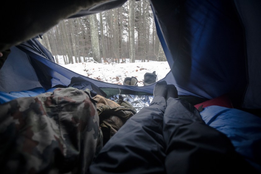 Personal Perspective of a Man Camping in Winter Forest.