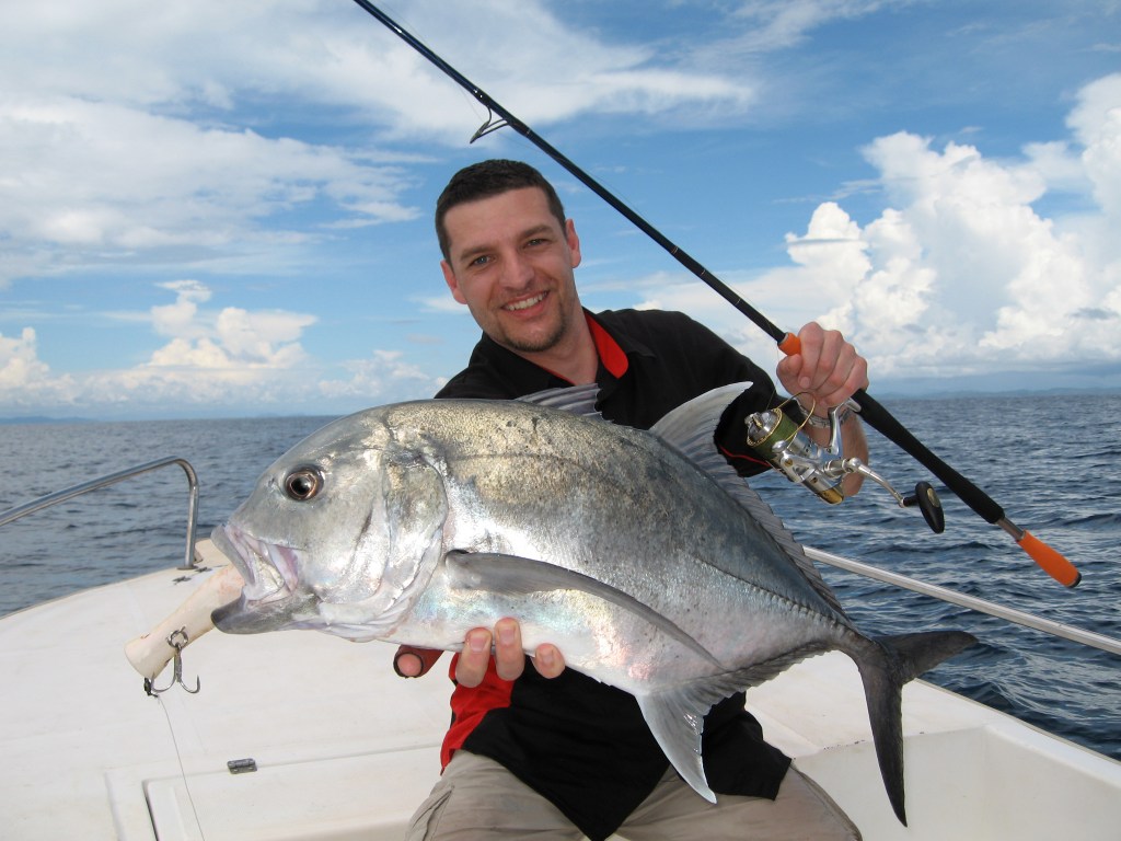 Deep sea fishing. Boat fishing, lucky fisherman holding a big trevally jack