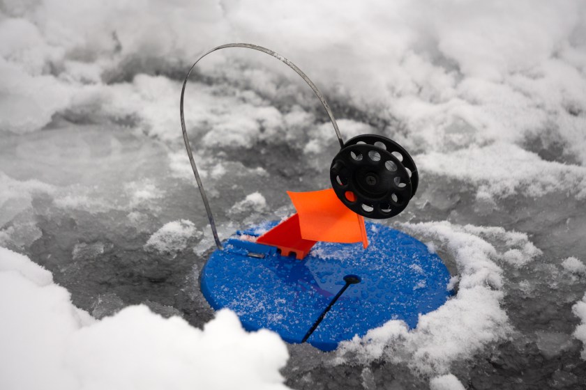 Ice fishing with a tip up.