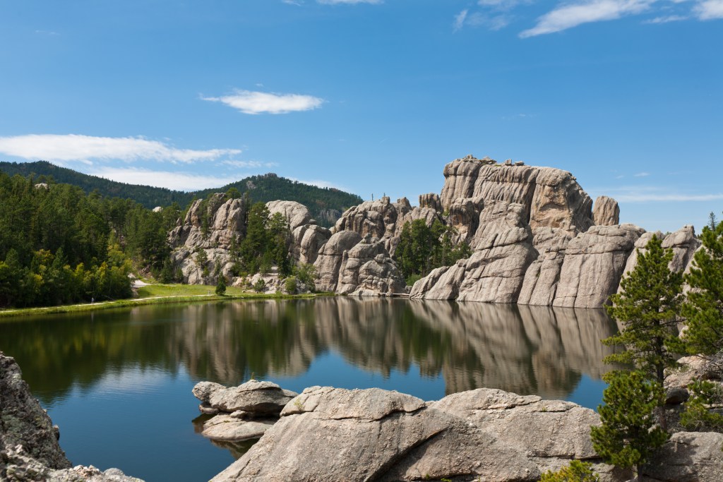 "Black Hills landscape- a beautiful Sylvan Lake with granite hills and pine trees surrounding it on a sunny, summer day; South Dakota"