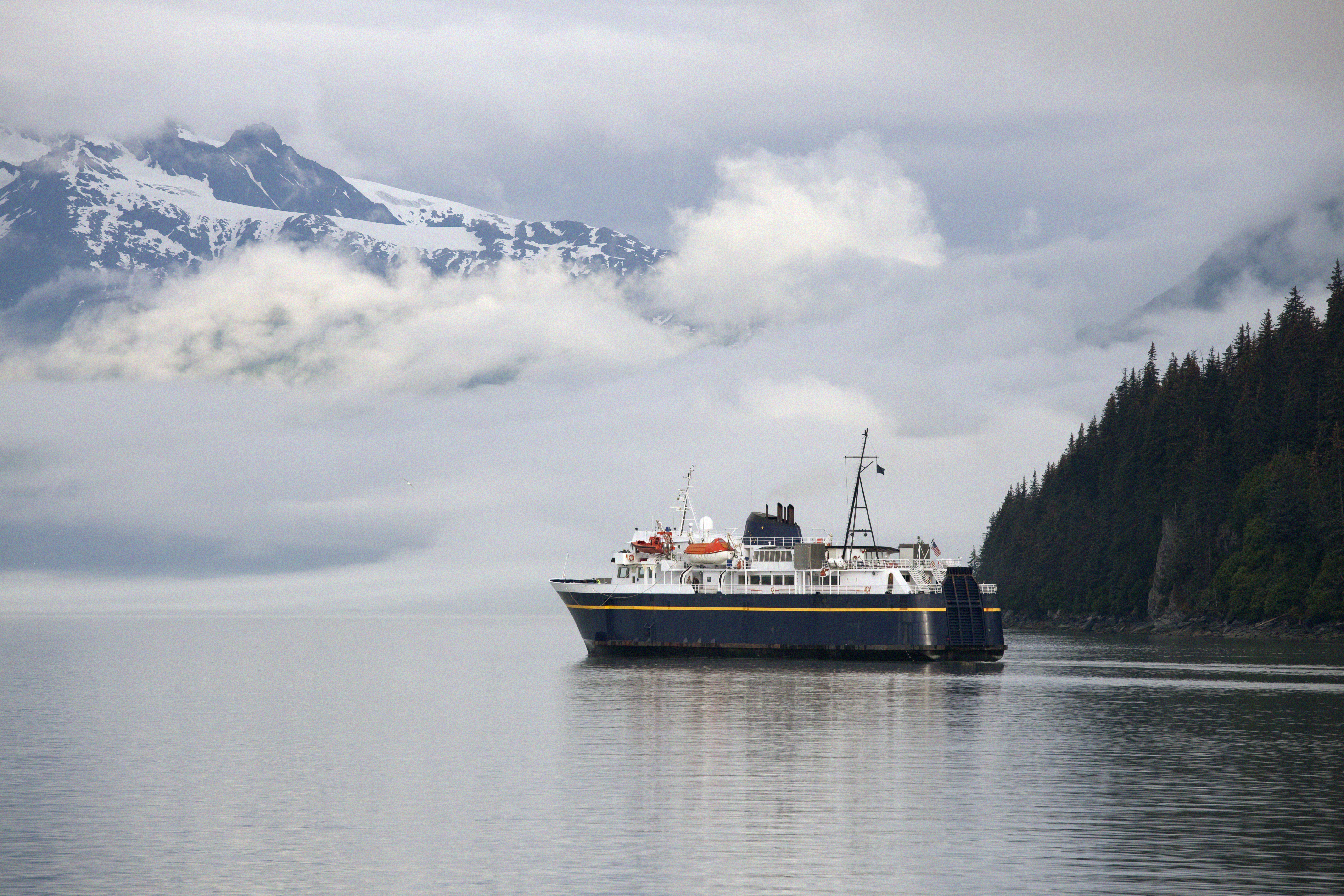 "Alaska Marine Highway ferry ship leaving Valdez Harbor, heading out to Prince William Sound waters."