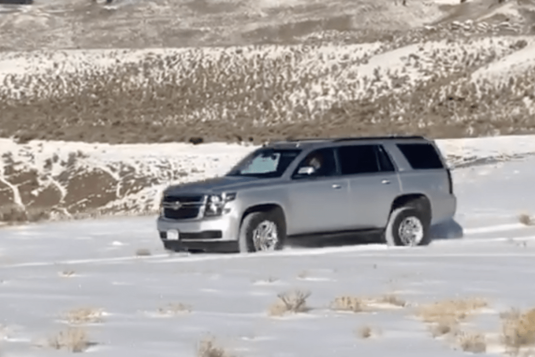 Tourist drives over frozen ground in Yellowstone.