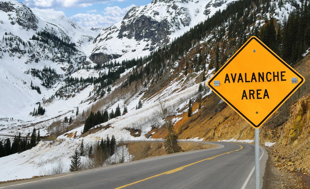 A sign warns motorists in an area of southwest Colorado where an avalanche has recently covered the road.