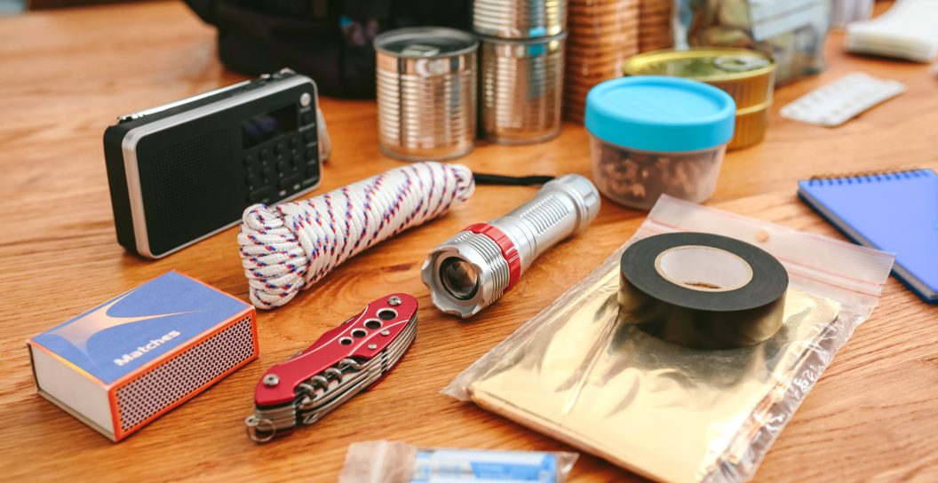 best bug out bags - Emergency backpack equipment organized on the table in the living room