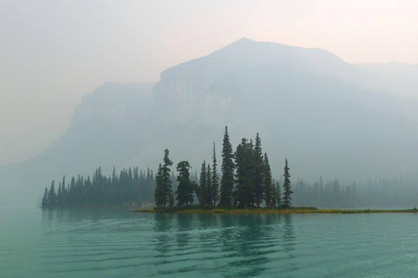 Spirit Island and Maligne Lake in wildfires smoke, Jasper national park, Canada.