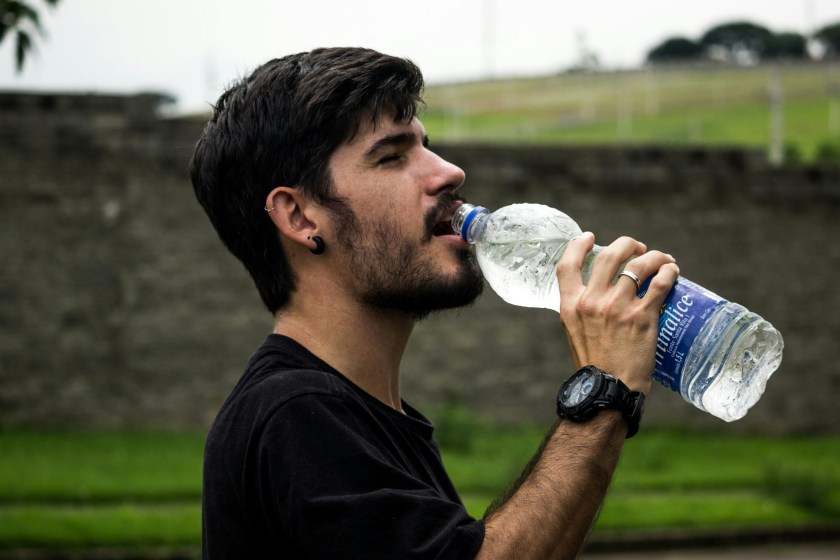 stay hydrated man drinking bottle of water